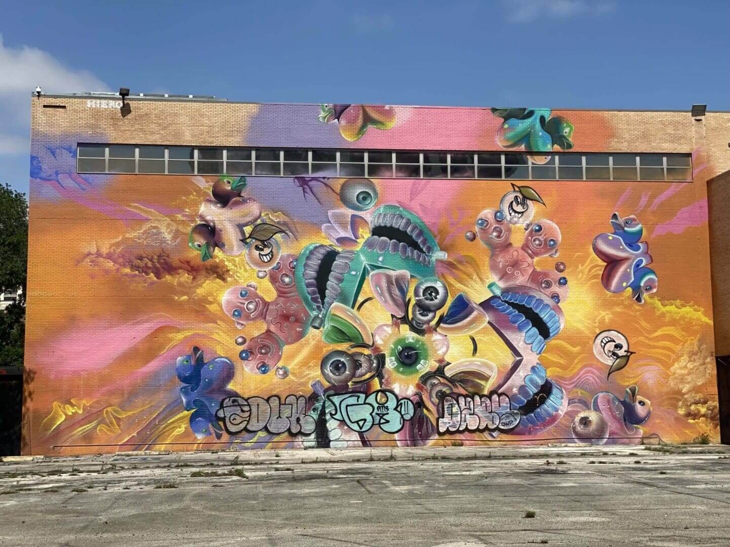 Colorful mural with abstract shapes and musical elements on an outdoor wall.