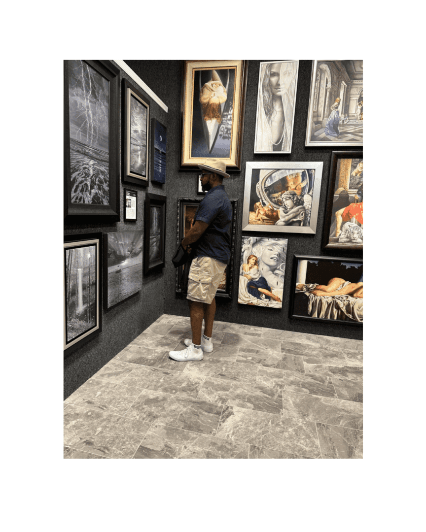 A child admires large framed artworks in a gallery.