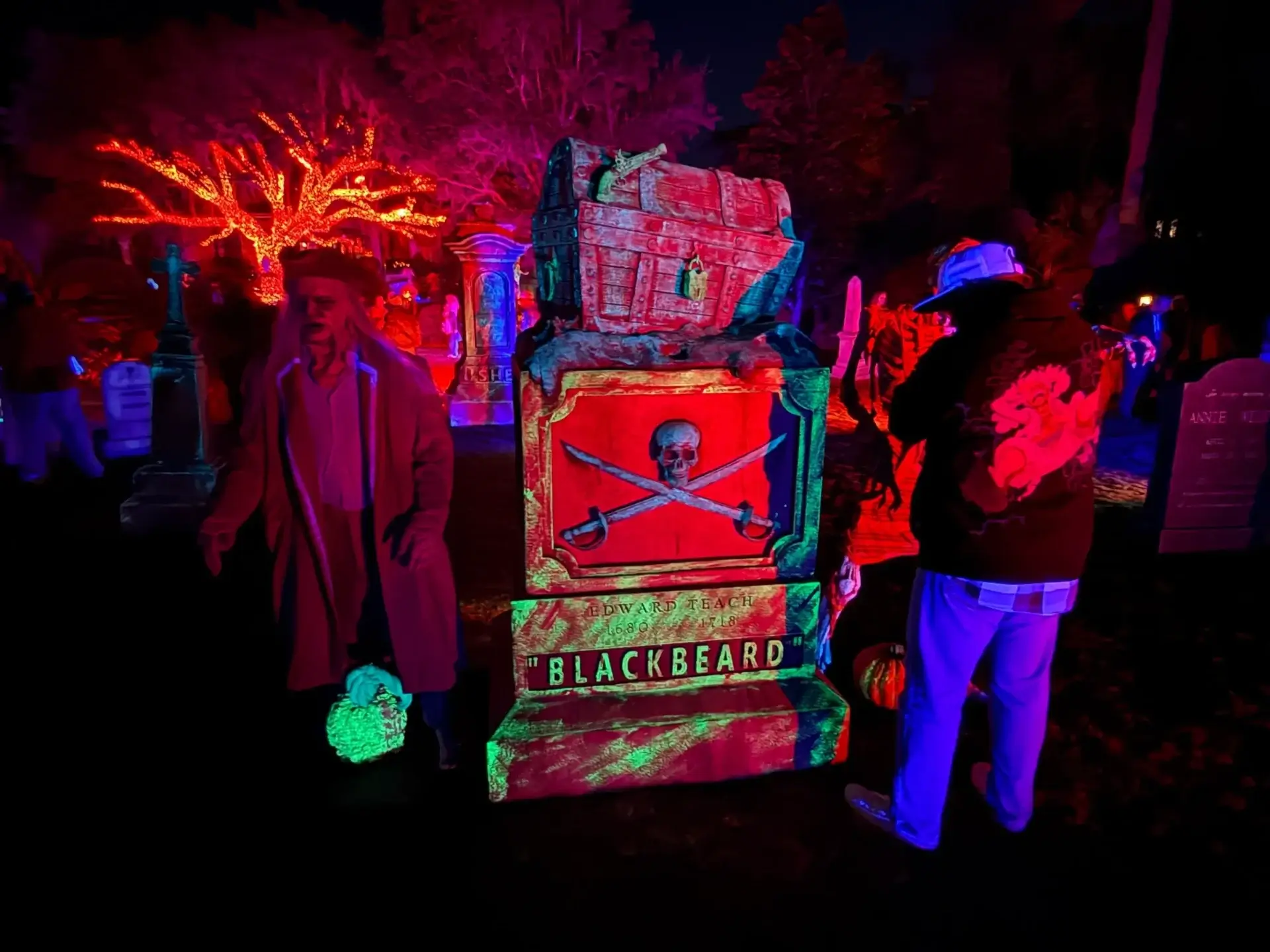 Pirate-themed Halloween decorations with neon lighting.