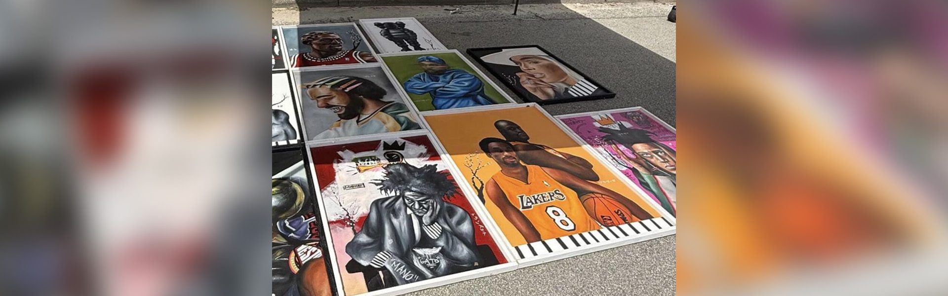 Street art display featuring various celebrity portraits.