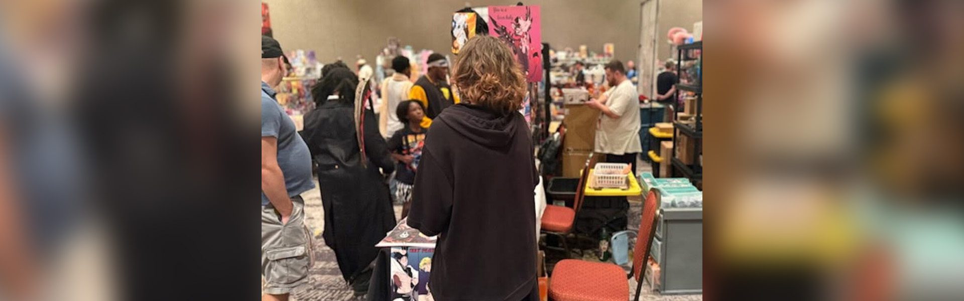 People browsing at a convention booth.