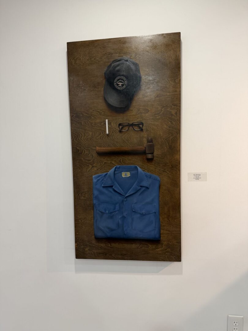 Uniform display with cap, glasses, and shirt.