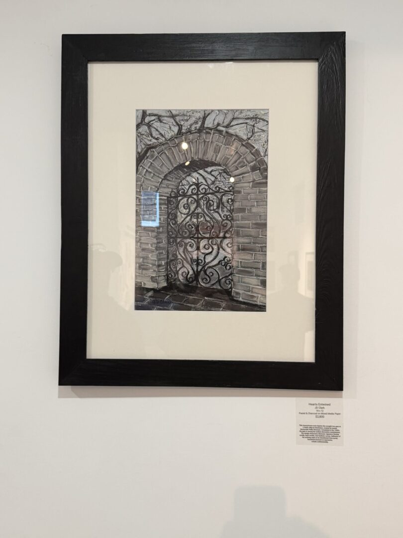 Framed artwork of ornate metal door design.