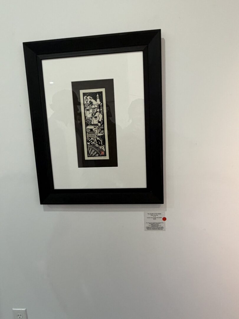 Framed artwork on a gallery wall.