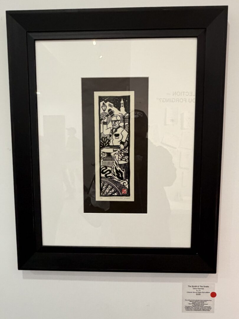 Framed black and white artwork on display.