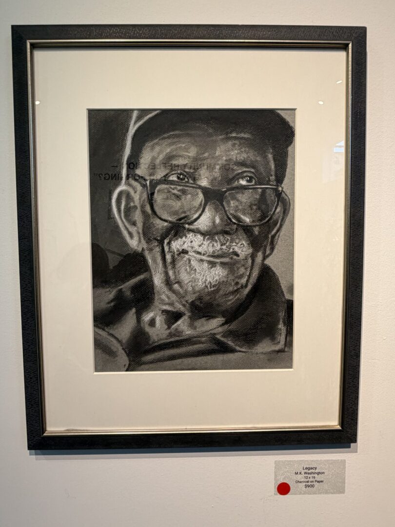 Portrait of an elderly man in glasses.