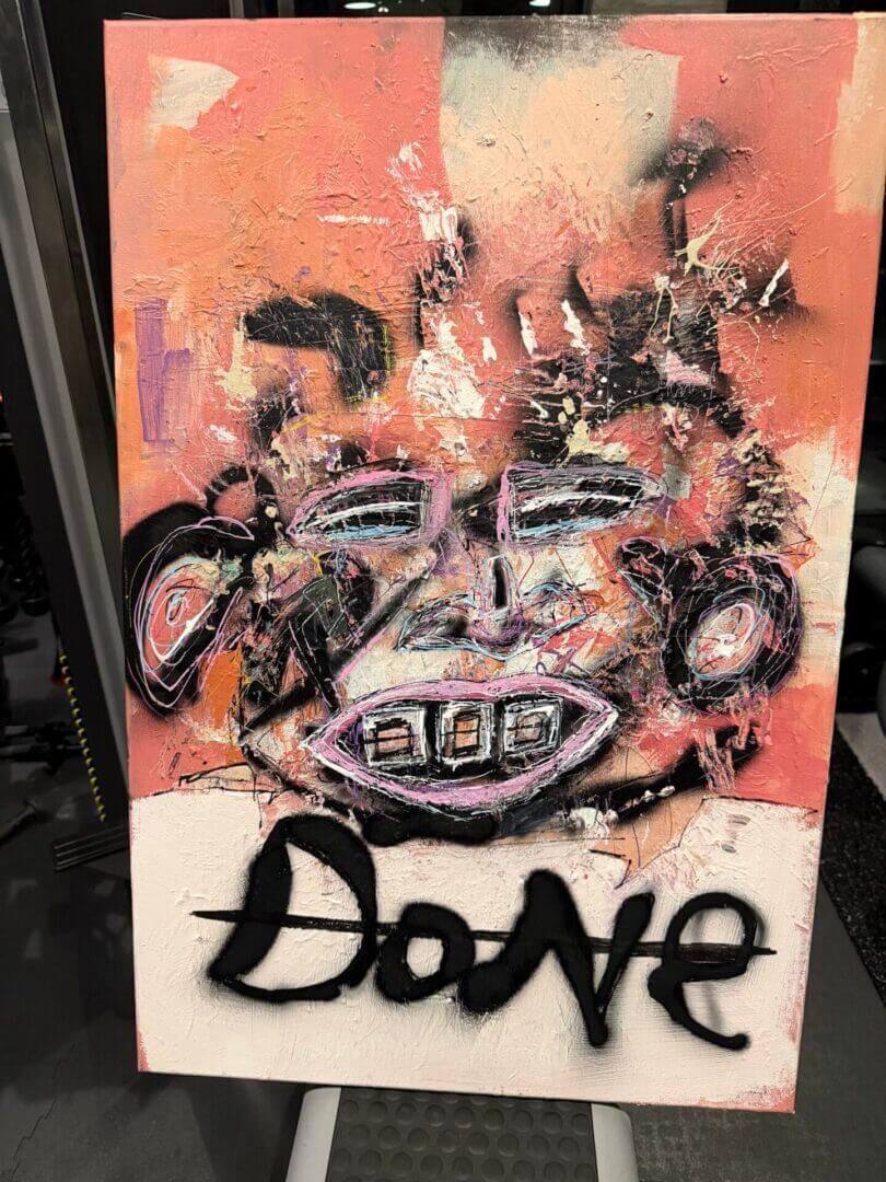 Abstract painting with face and "Done" text.