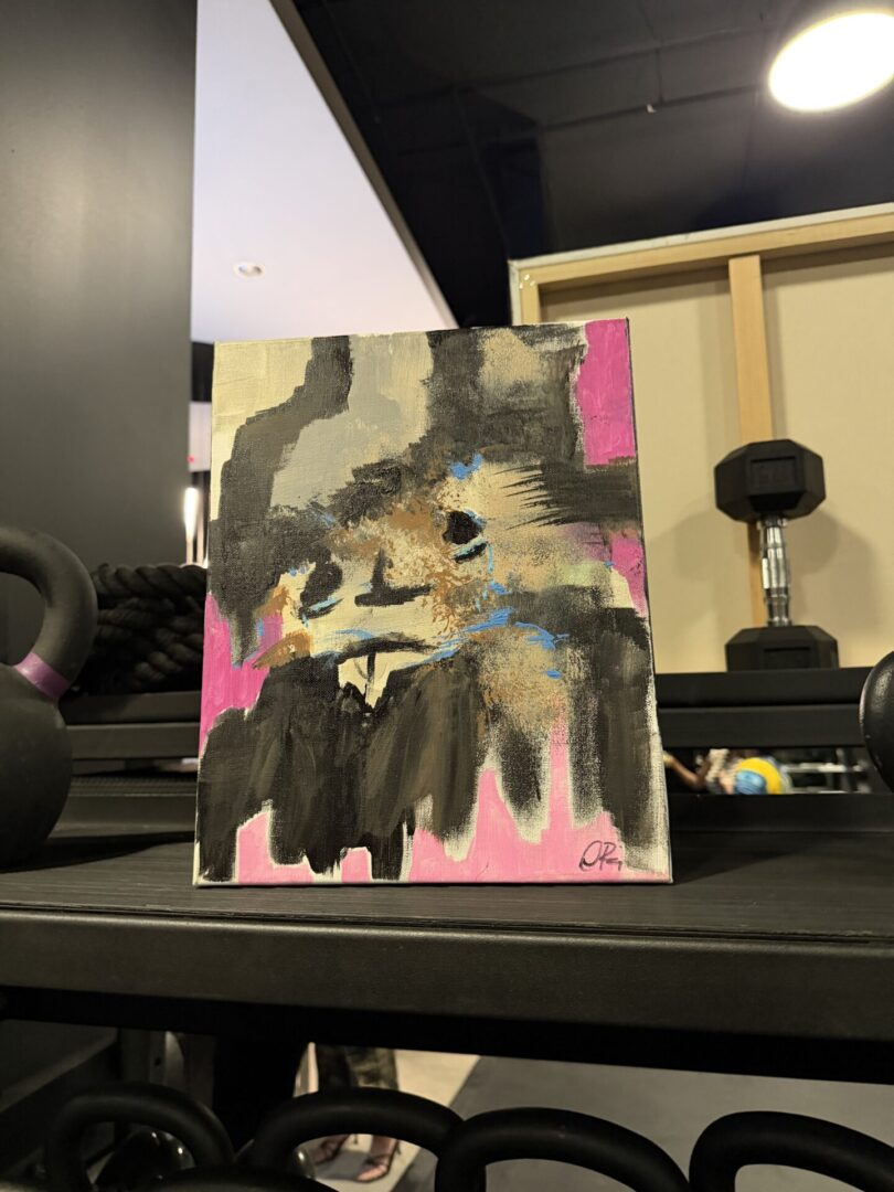 Abstract painting on display in gym setting.
