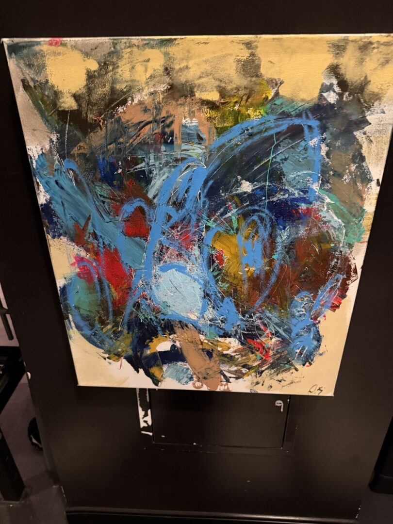 Abstract painting with vibrant blue and red.
