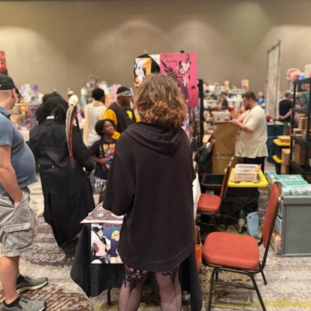 Crowded convention with people in costumes.